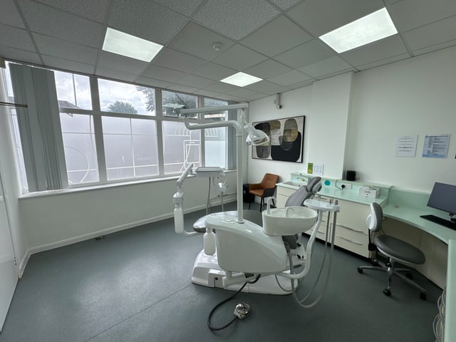 A GL1 Dental treatment room with worktop, sink and wall panel