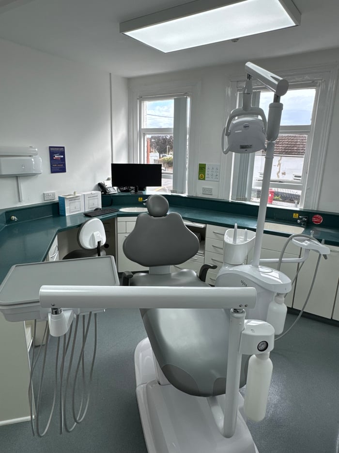 A dental surgery with treatment chair and monitor at GL1 Dental, Gloucester